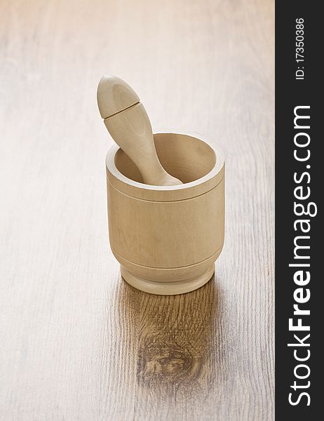 Mortar with pestle on wooden background