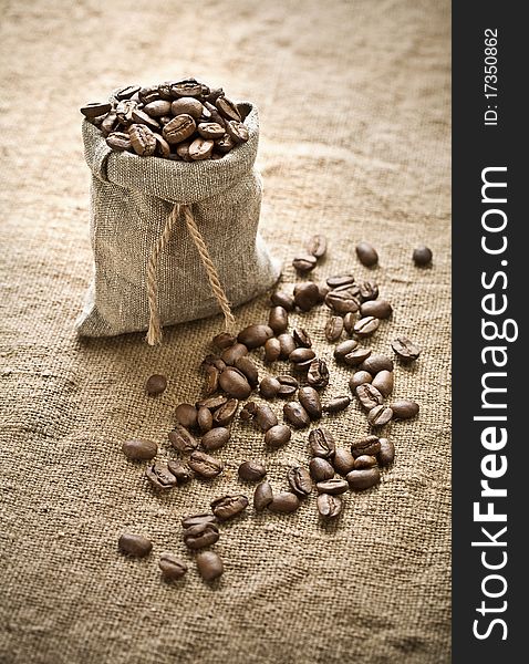 Coffee beans in bag of burlap on sacking. Coffee beans in bag of burlap on sacking