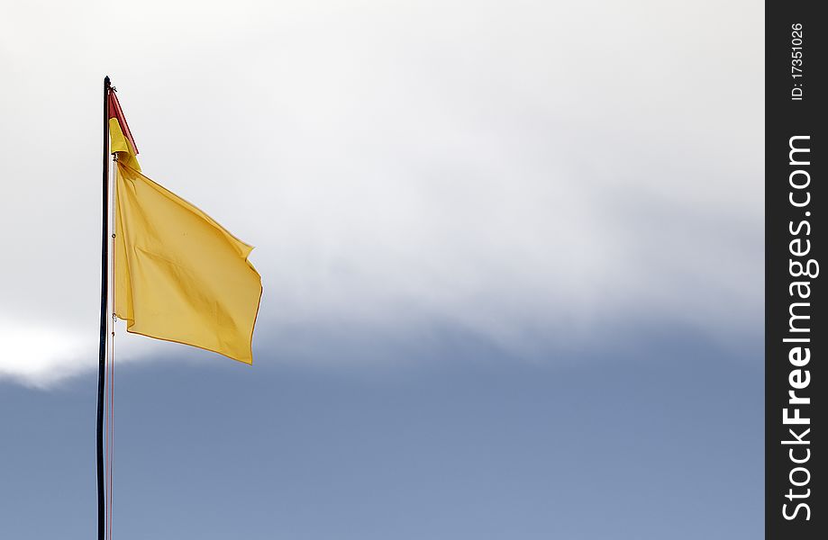 A red and yellow swimming safety flag on an Lithuanian beach