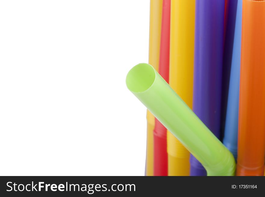 Plastic tubes of different colors in the background.