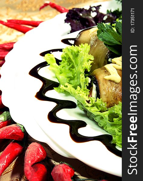 Appetizer made of rolled egg-plants served with salad. Appetizer made of rolled egg-plants served with salad