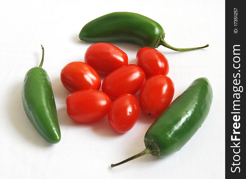 Composition of green hot peppers and cherry tomatoes