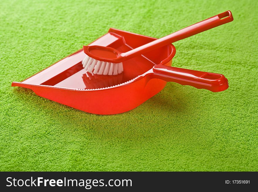 Dustpan with brush on green towel