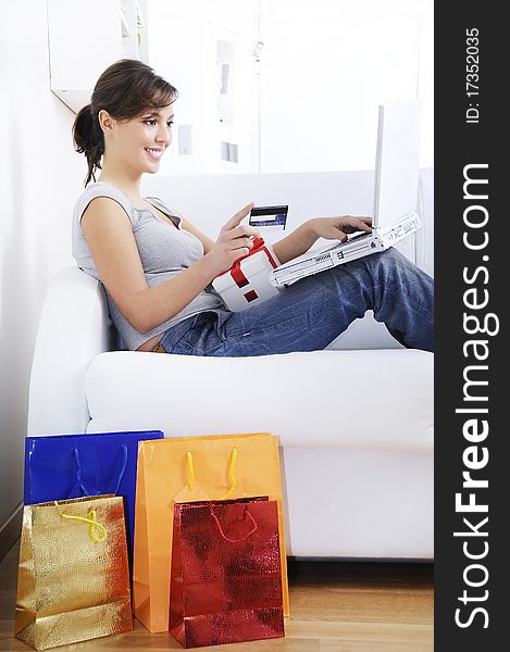 Happy shopping on-line of young woman with laptop on internet. Happy shopping on-line of young woman with laptop on internet