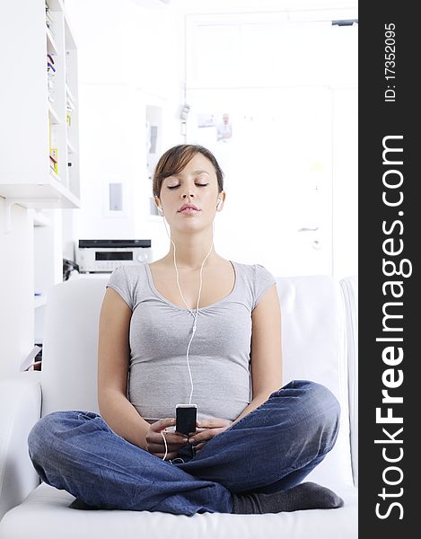 Young Woman Listening Music In Home Interior