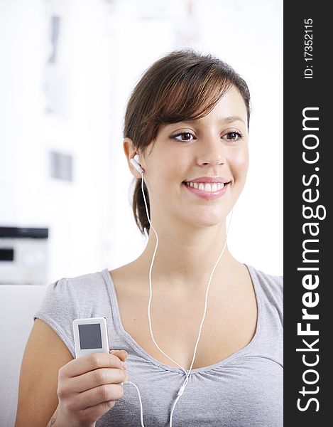 Young woman listening music in home interior