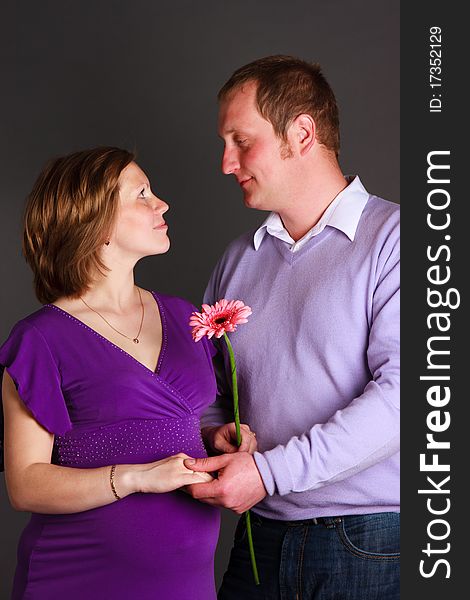 Pregnant woman with flower and her husband. Pregnant woman with flower and her husband