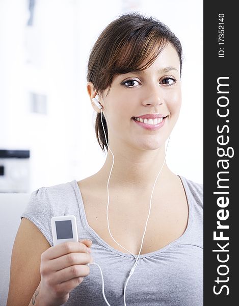 Young Woman Listening Music In Home Interior