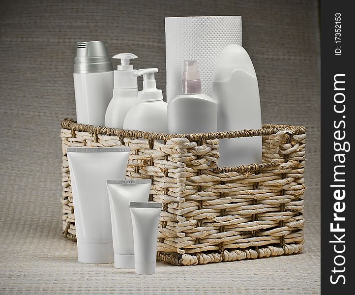 Bottles and tubes in basket on a background of mat. Bottles and tubes in basket on a background of mat