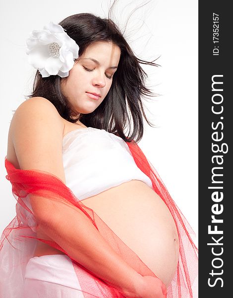 Beautiful pregnant woman staing on light grey background, close up