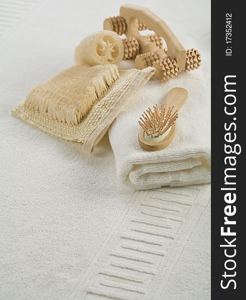 Massager bath hairbrush and towel on white towel. Massager bath hairbrush and towel on white towel