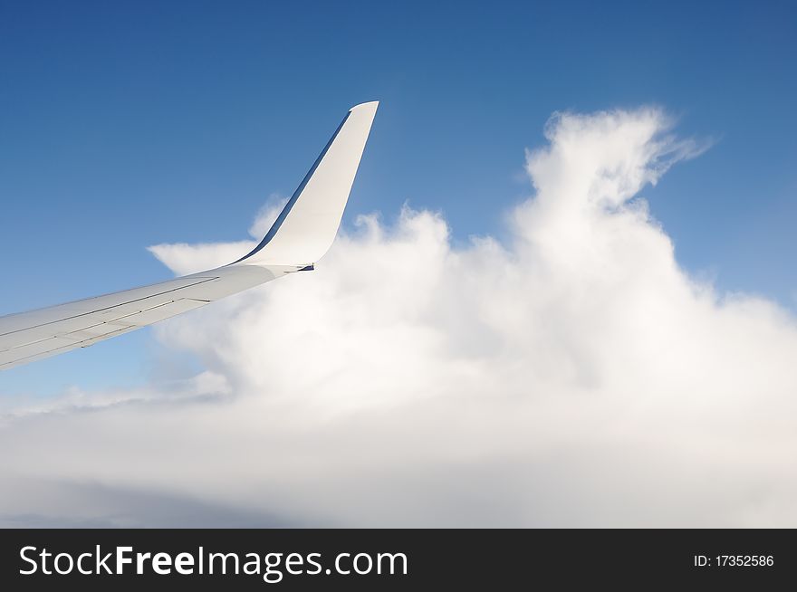 View of plane window with clouds