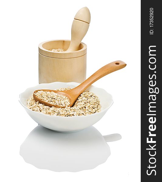 Cereals in dish with spoon and mortar