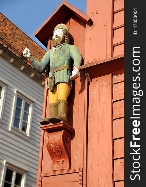 Figure on a facade of the ancient wooden house in Bergen, Norway