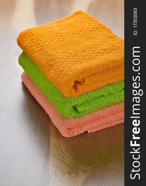 Collection of bath towels on wooden background. Collection of bath towels on wooden background