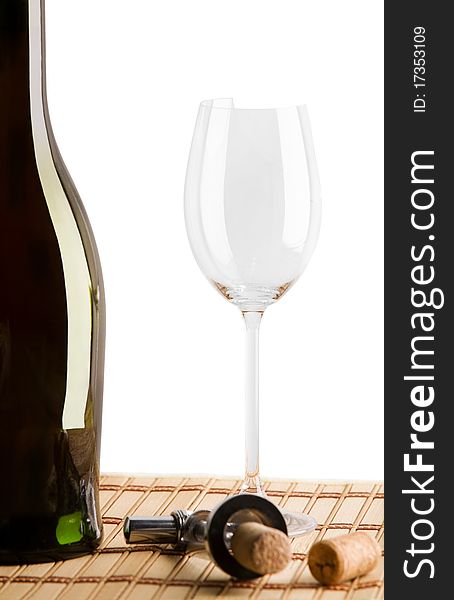 Composition of bottle and brokeh glass and corks with white isolated field