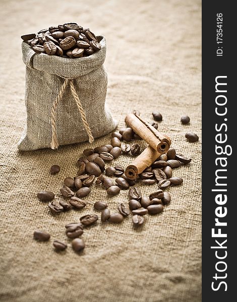 Composition of coffee beans and cinnamon on sacking