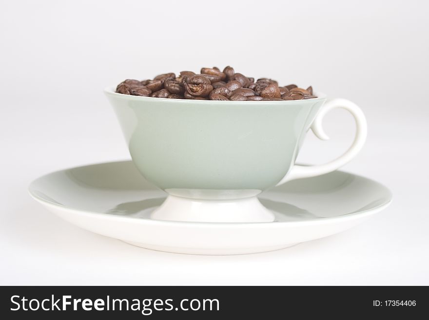 Coffee Beans in Cup with Saucer