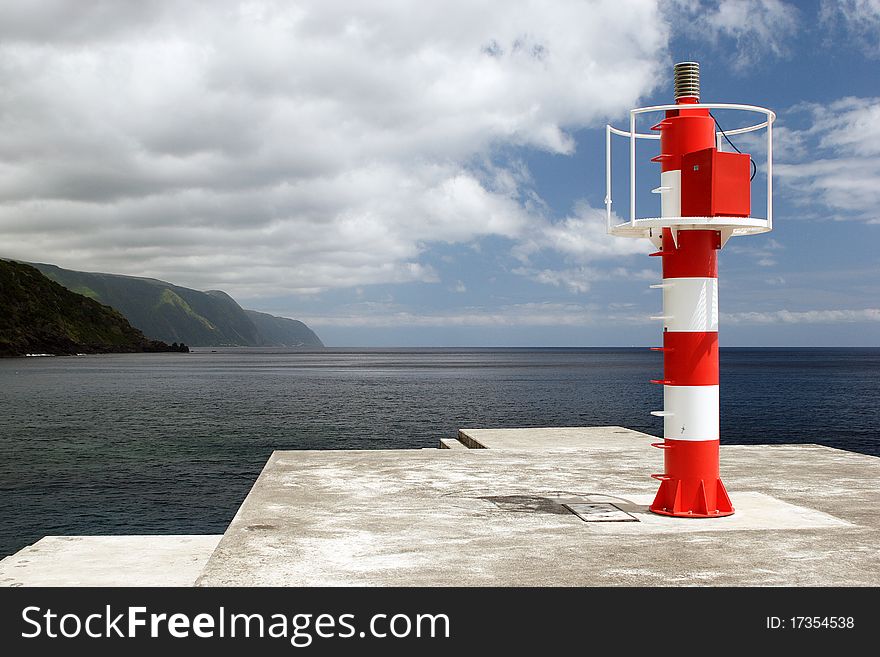 The red white striped beacon on coast