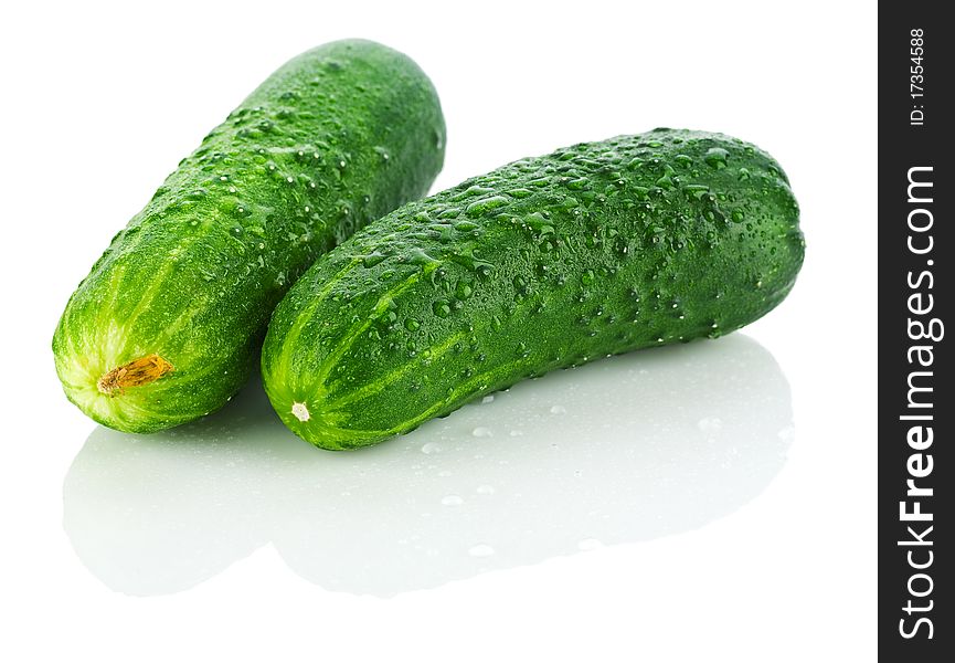 Fresh dropped cucumbers isolated on white background