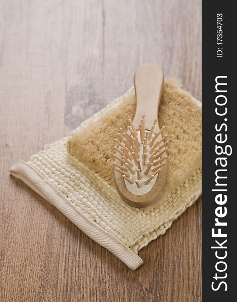 Hairbrush on bast on wooden background