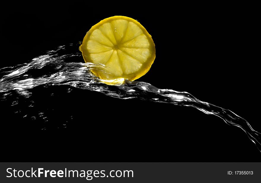 Lemon with splashing water on a black background. Lemon with splashing water on a black background