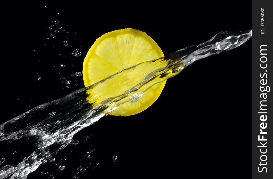 Lemon with splashing water on a black background. Lemon with splashing water on a black background