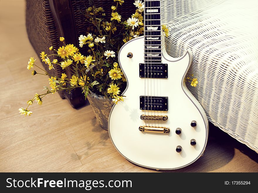 White  electric guitar with flowers