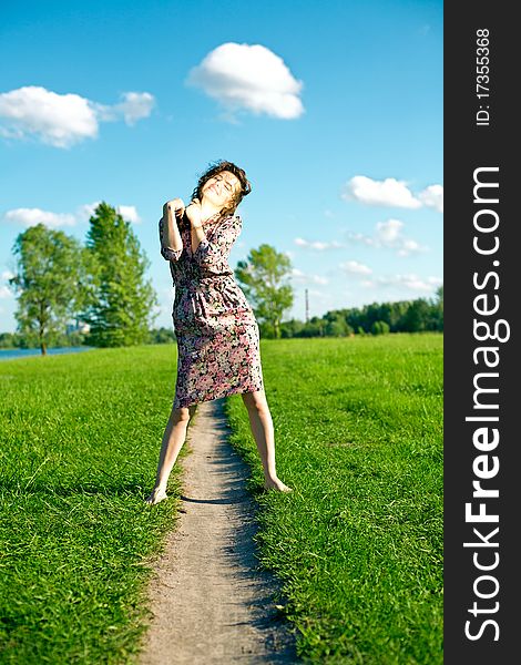 Young woman on meadow with green grass