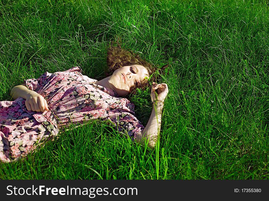 Beautiful girl lying down of grass