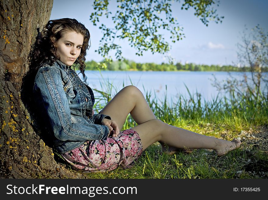 Beautiful Young Woman Relaxing Near River