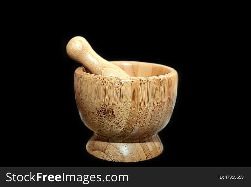 Wooden mortar on black background