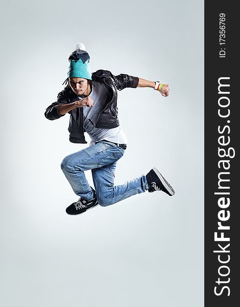 Modern style dancer jumping on studio background. Modern style dancer jumping on studio background