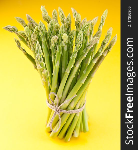 Sheaf of asparagus on a yellow background. Sheaf of asparagus on a yellow background.