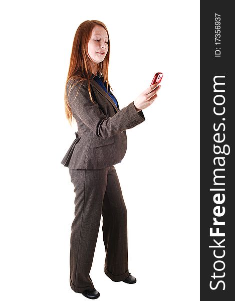 A business woman in a brown suit standing in profile in the studio,
with her long red hair and dialing on her cell phone for white background. A business woman in a brown suit standing in profile in the studio,
with her long red hair and dialing on her cell phone for white background.