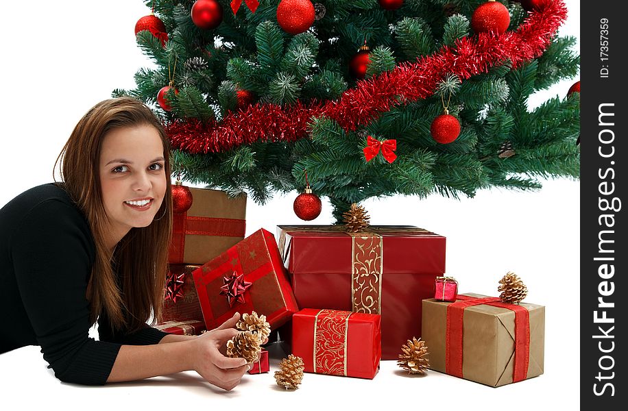 Young beautiful girl near the Christmas tree with lots of presents. Young beautiful girl near the Christmas tree with lots of presents
