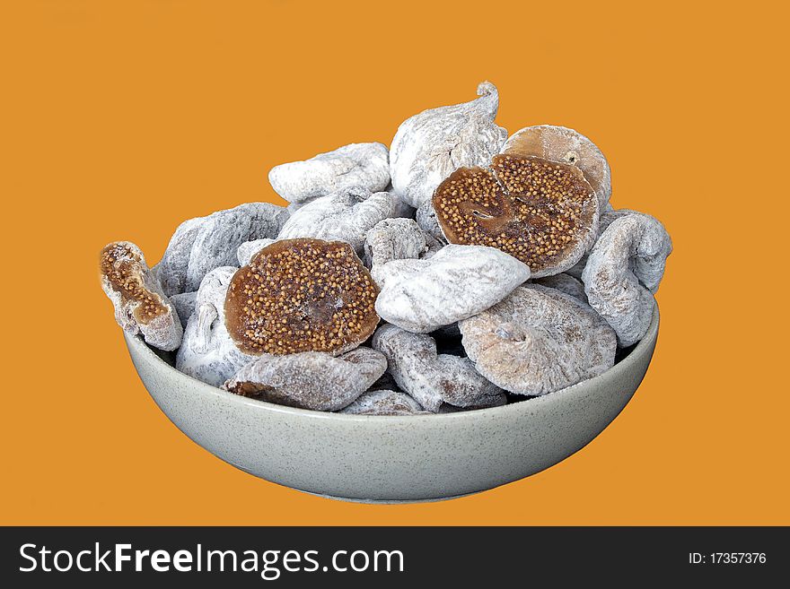 Dried figs in ceramic cup in isolated