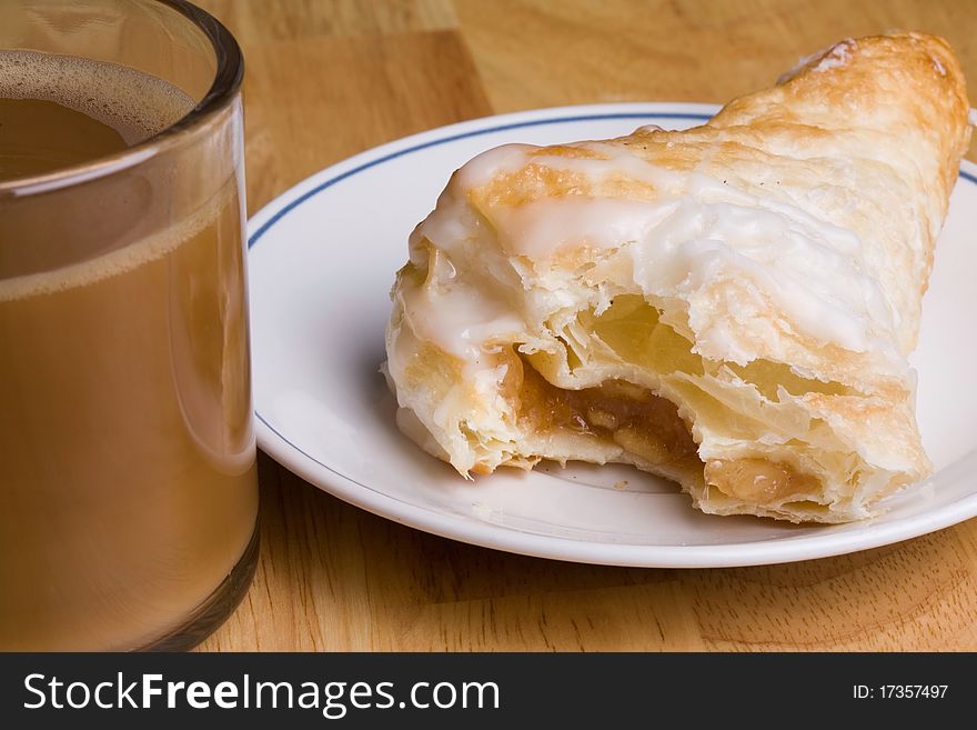 Coffee and an fresh apple turnover for breakfast. Coffee and an fresh apple turnover for breakfast