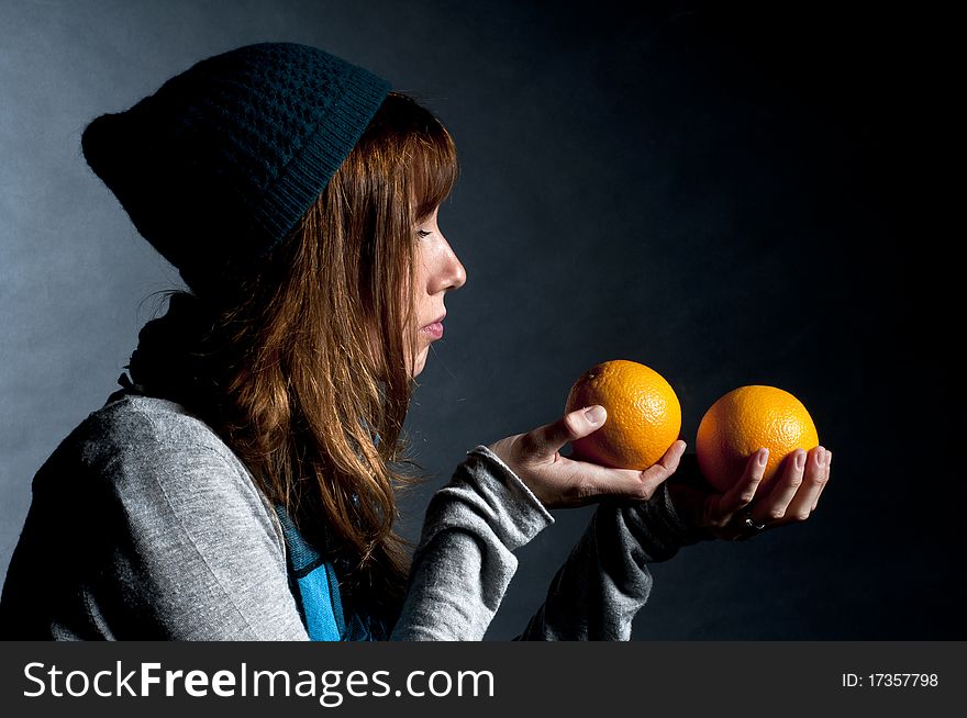 Girl with orange and hat with black background