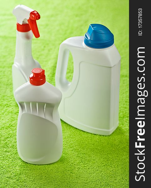 Three white kitchen cleaners on  green background. Three white kitchen cleaners on  green background