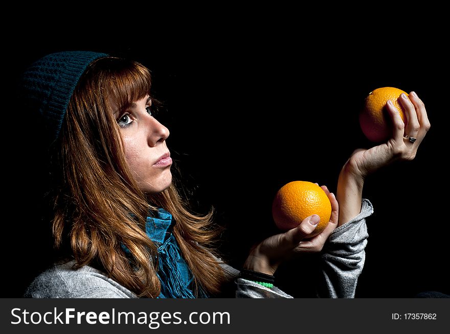 Girl with orange and hat with black background