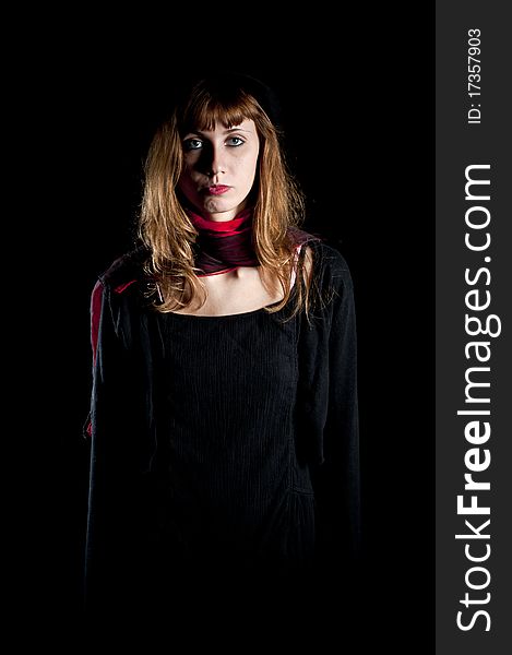 Dark girl with hat and red scarf on black background