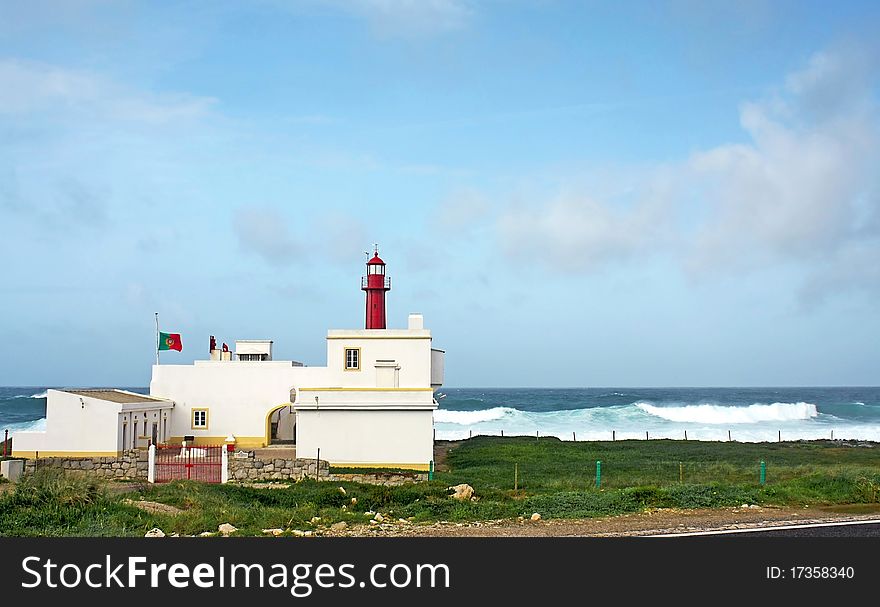 Lighthouse shallow cape with wavy sea as background