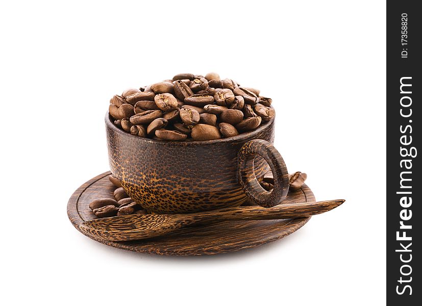 Brown wooden cup of teak tree with coffee beans