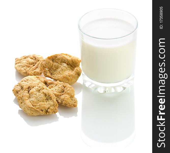 Cookies with glass of milk isolated on white background with reflection on white blurry background. Cookies with glass of milk isolated on white background with reflection on white blurry background