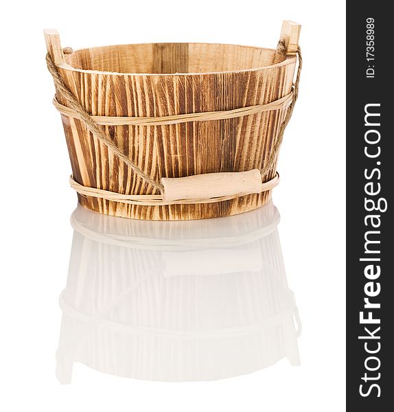 One brown empty wood bucket isolated on white background with reflection on white blurry background. One brown empty wood bucket isolated on white background with reflection on white blurry background