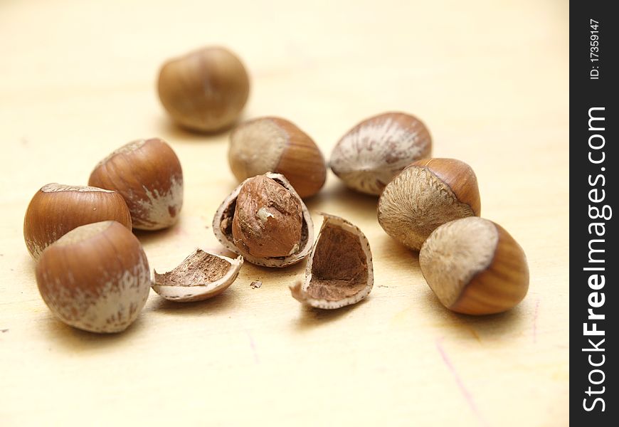 Hazelnuts on a table, one shelled