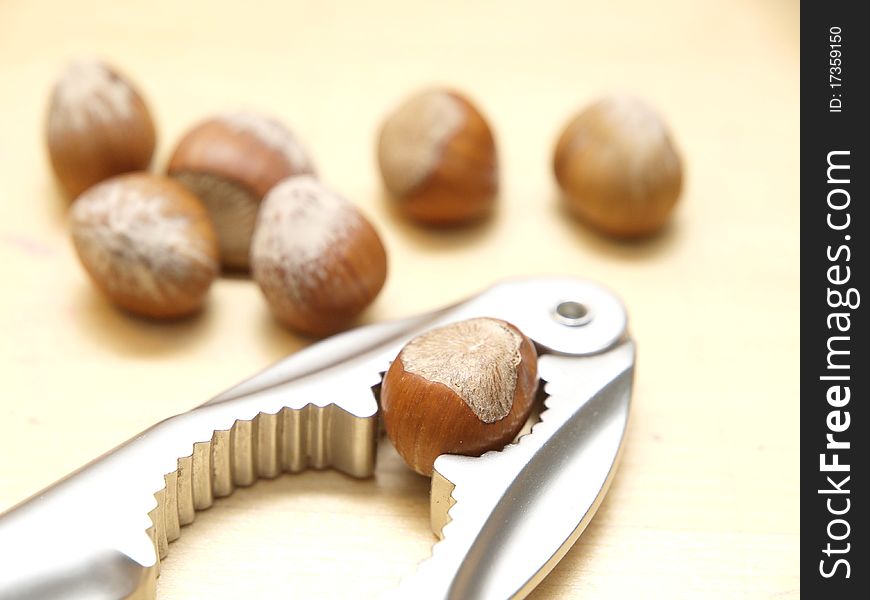 Hazelnuts on a table and a nutcracker