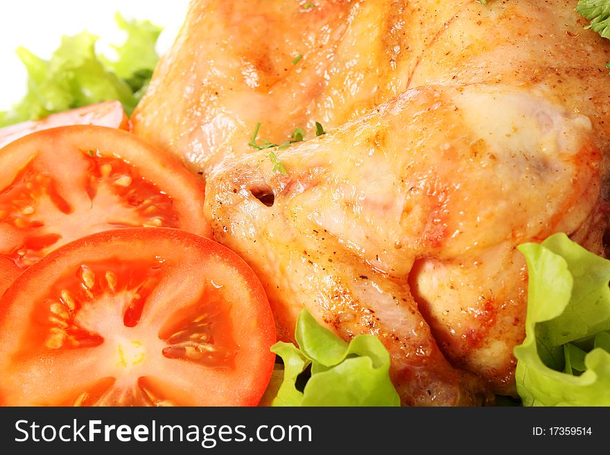 Roast chicken on leaves salad on a white background is isolated. Roast chicken on leaves salad on a white background is isolated.