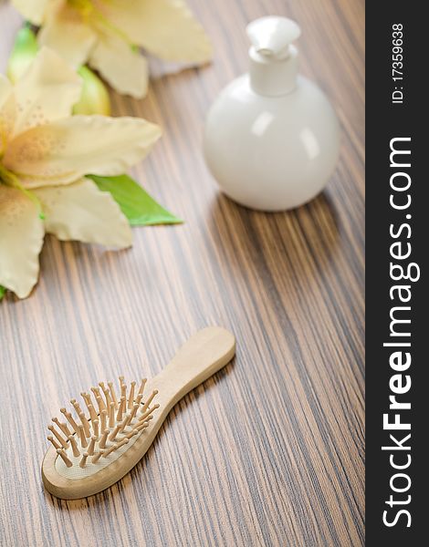 Round Bottle And Hairbrush With Flower